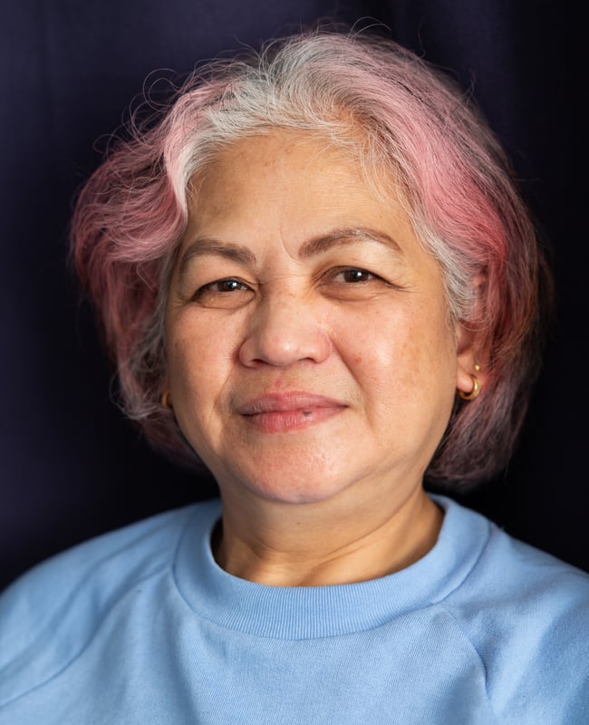 Photo: A woman with brightly colored hair smiles to the camera.
