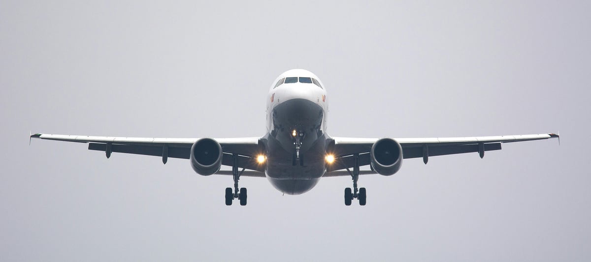 Front view of an airplane in the air.