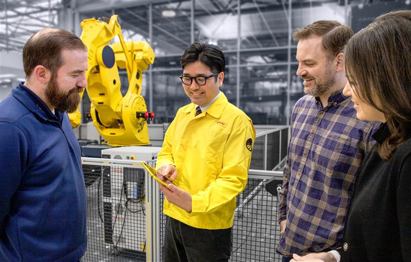 FANUC Employee Interacting with Customers Smiling