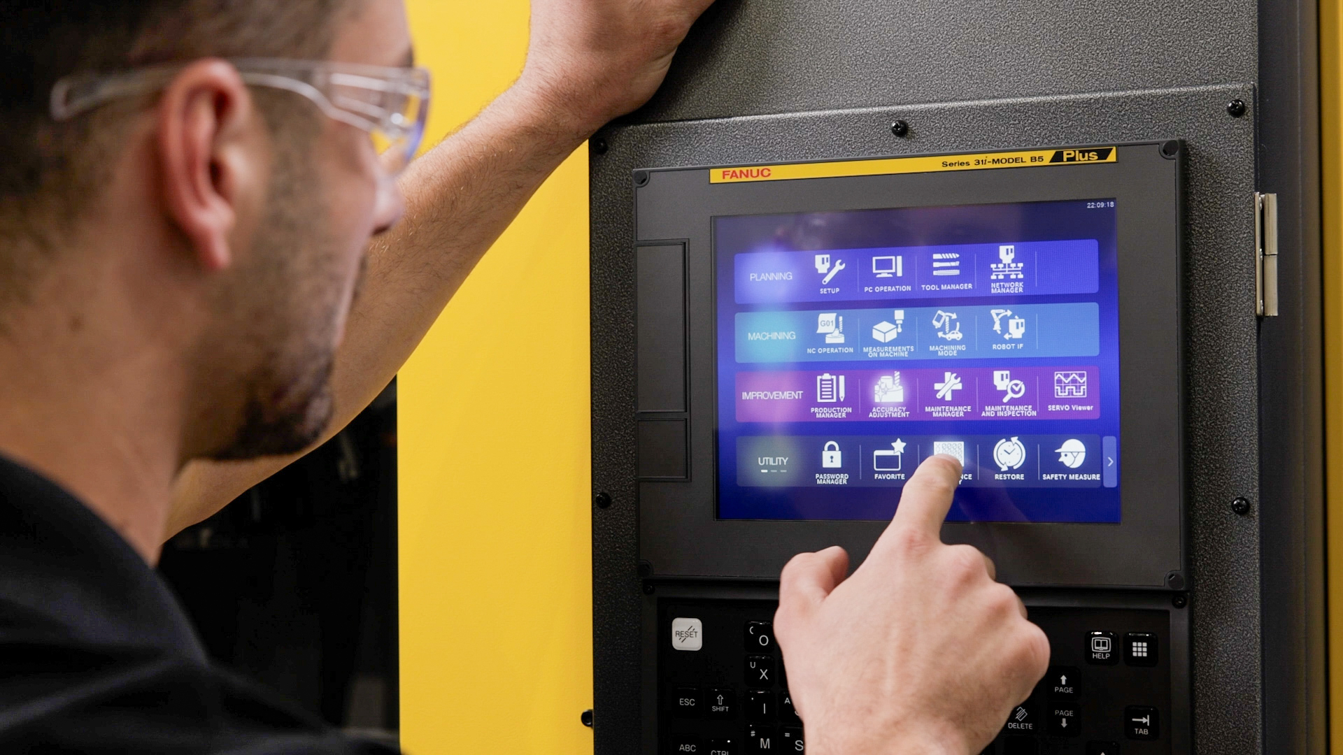 ROBODRILL Plus Technician Interacting With Series 31i MODEL B5 Plus CNC Panel