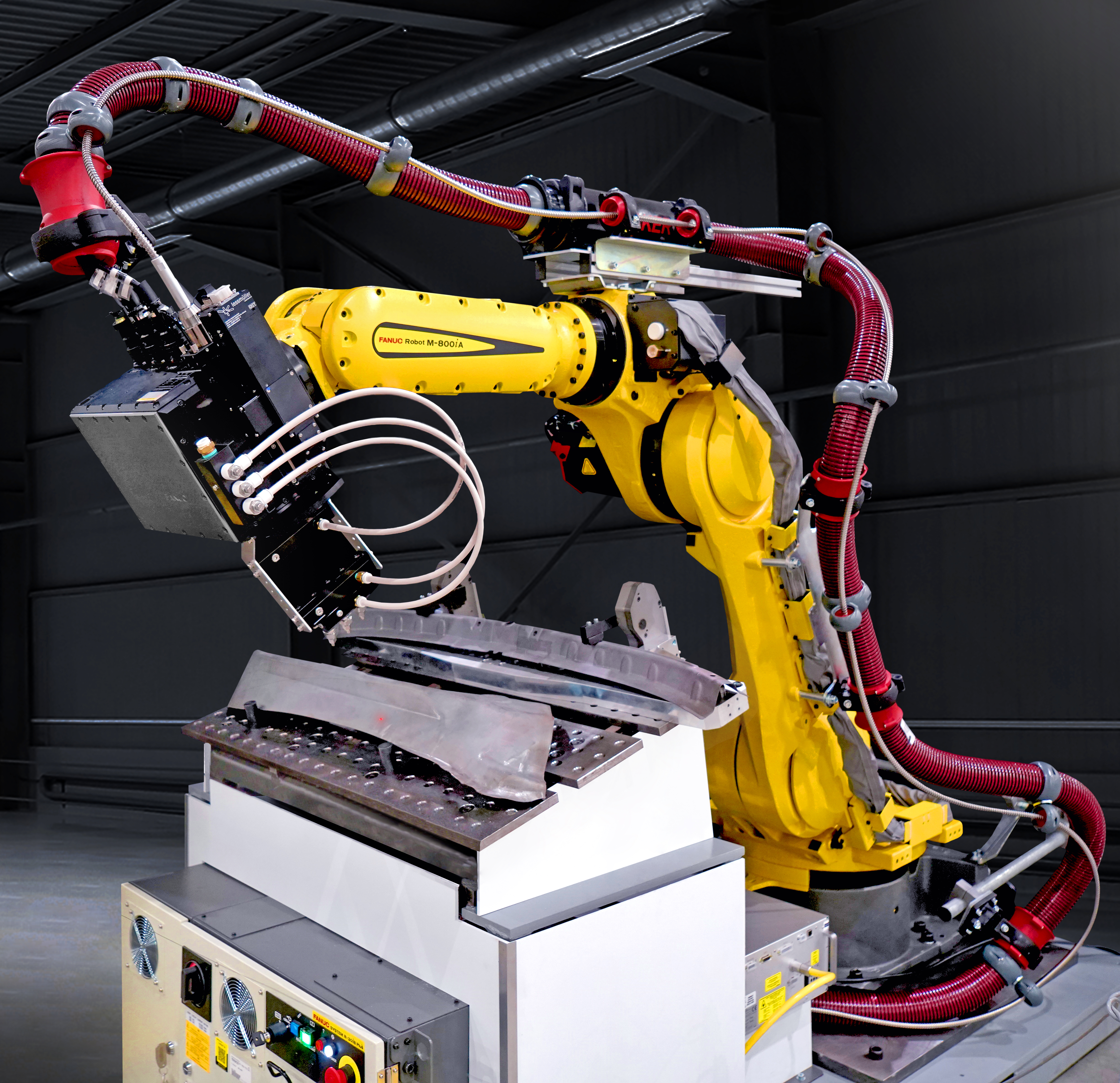 FANUC M-800iA/60 robot using laser scanner end-of-arm tooling to scan manufactured parts