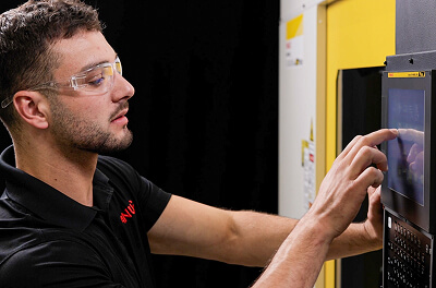 Robodrill plus technician interacting with cnc side view