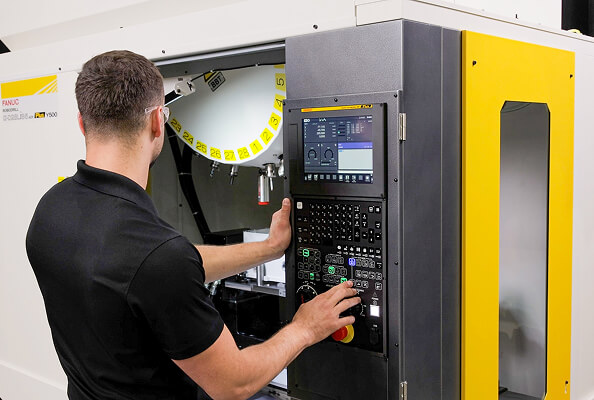 Technician operating robodrill plus y500