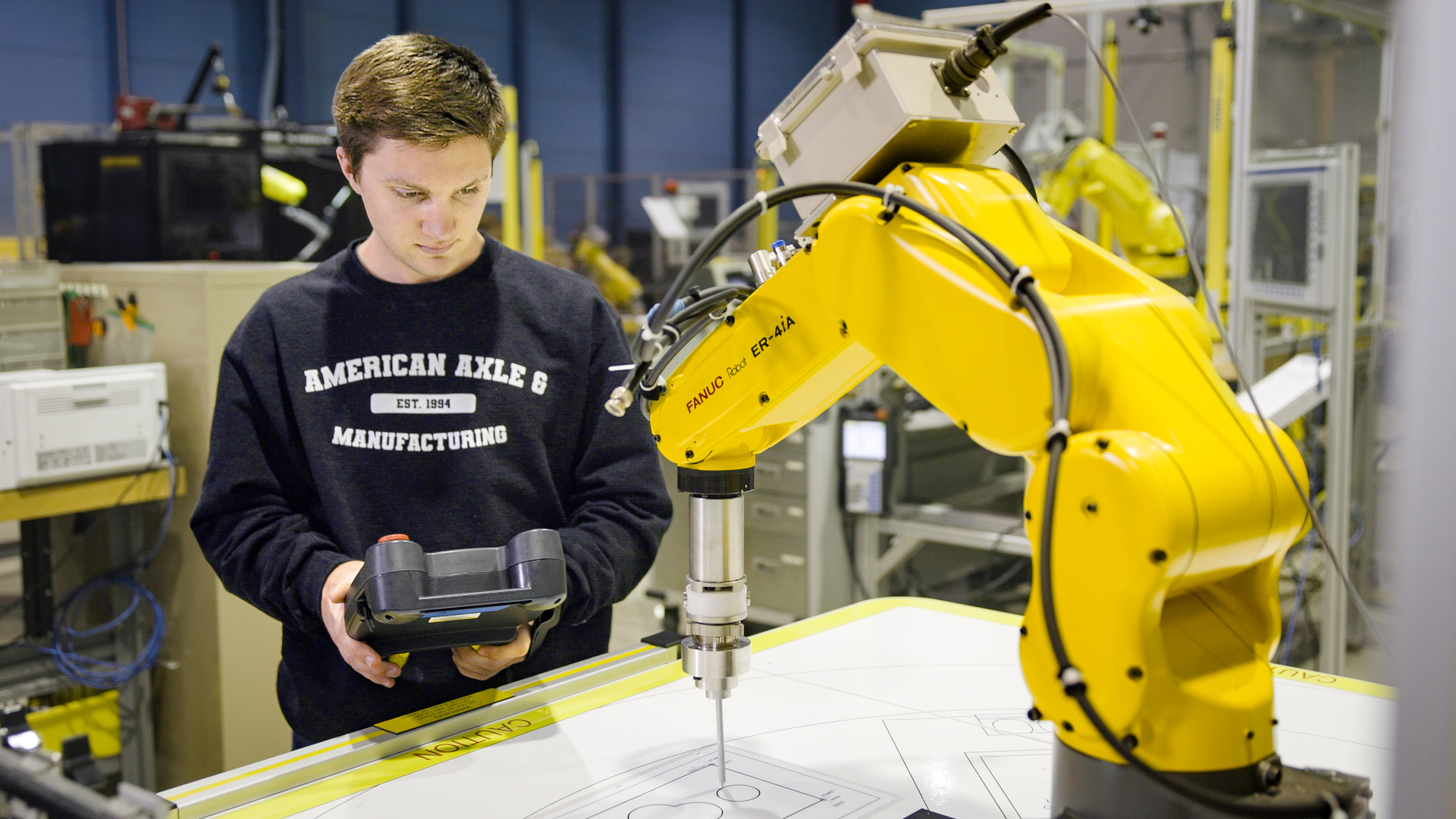 Student Interacting with a ER 4i A Robot Cell