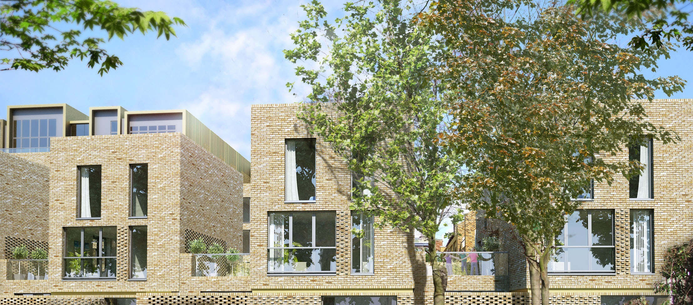 Modern brick residential buildings with large windows and geometric facades, surrounded by green trees under blue sky.