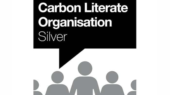 Black speech bubble with white text "Carbon Literate Organisation Silver" above grey silhouettes of people on white background.