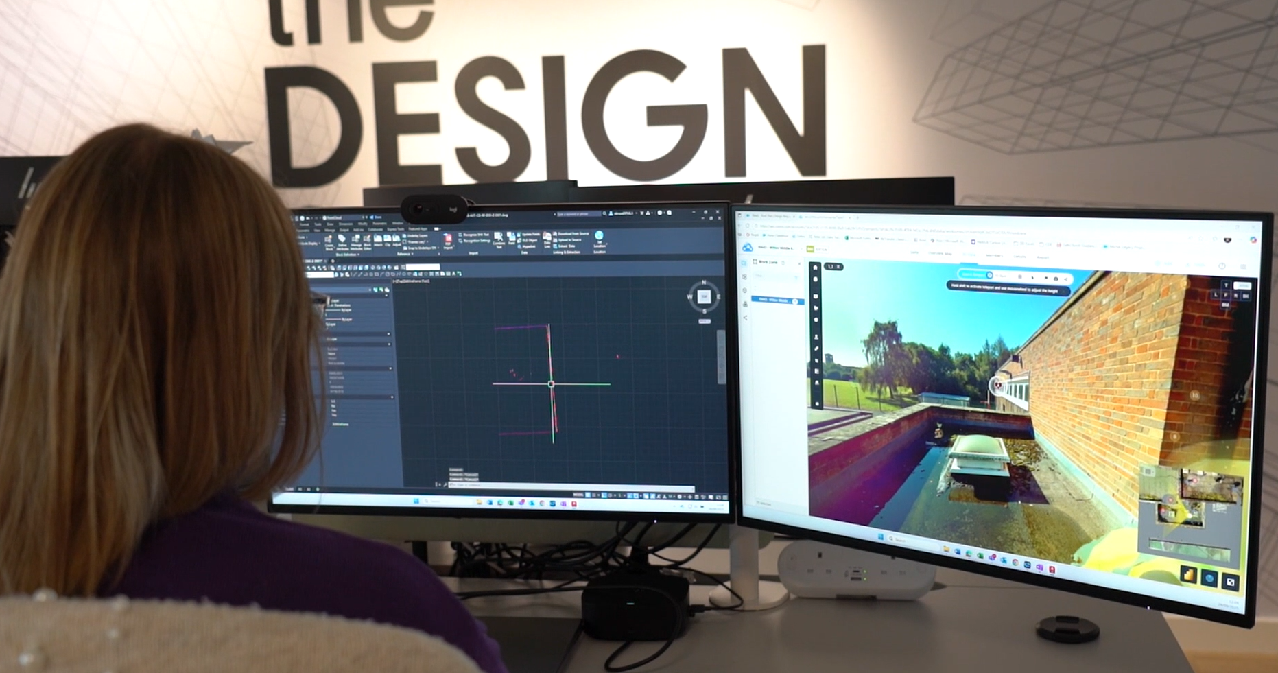 Person with blonde hair working at dual monitors showing CAD software and 3D architectural rendering under "DESIGN" wall text.