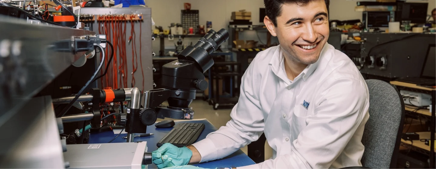 VPT employee smiling while working on DC-DC Converters