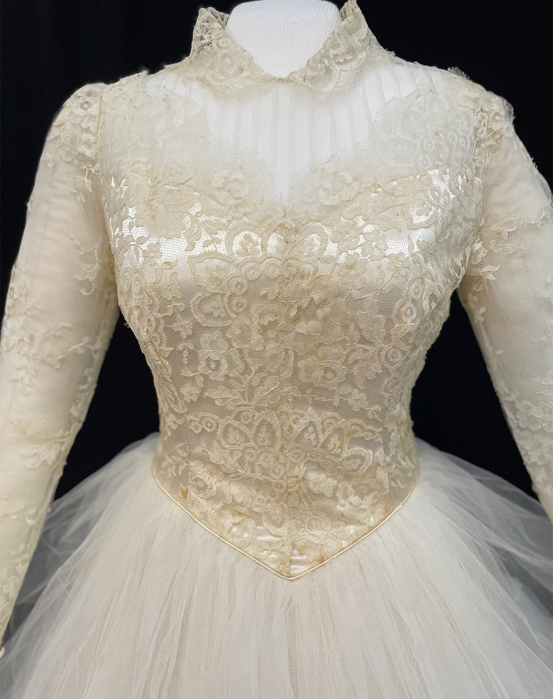 Photo showing a tea-length wedding gown of tulle and hand-clipped rosepoint lace.