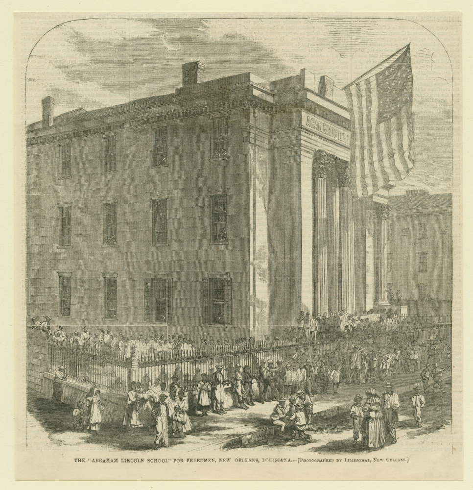 A vintage illustration of the Abraham Lincoln School for Freedmen in New Orleans. The building is large and rectangular, adorned with columns and an American flag. A crowd of people, including children, gathers outside near a picket fence.