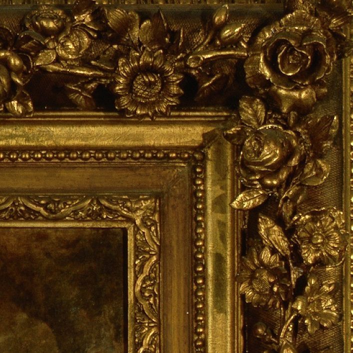 Close-up of an ornate, golden picture frame with intricate floral and leaf patterns carved in relief along the border. The rich texture and detailed design feature roses and other flowers, giving a luxurious and classic appearance.