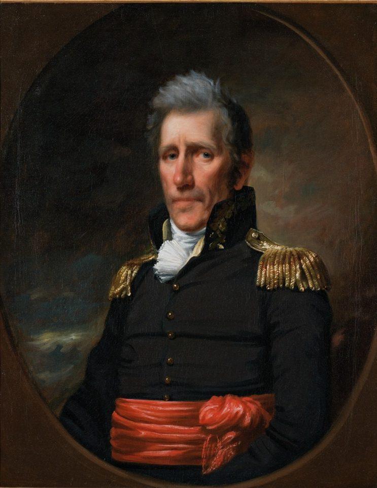 A historical portrait of a man in military attire with gold epaulettes and a red sash, set against a dark, cloudy background. The man has short, gray hair and a solemn expression, looking directly at the viewer.