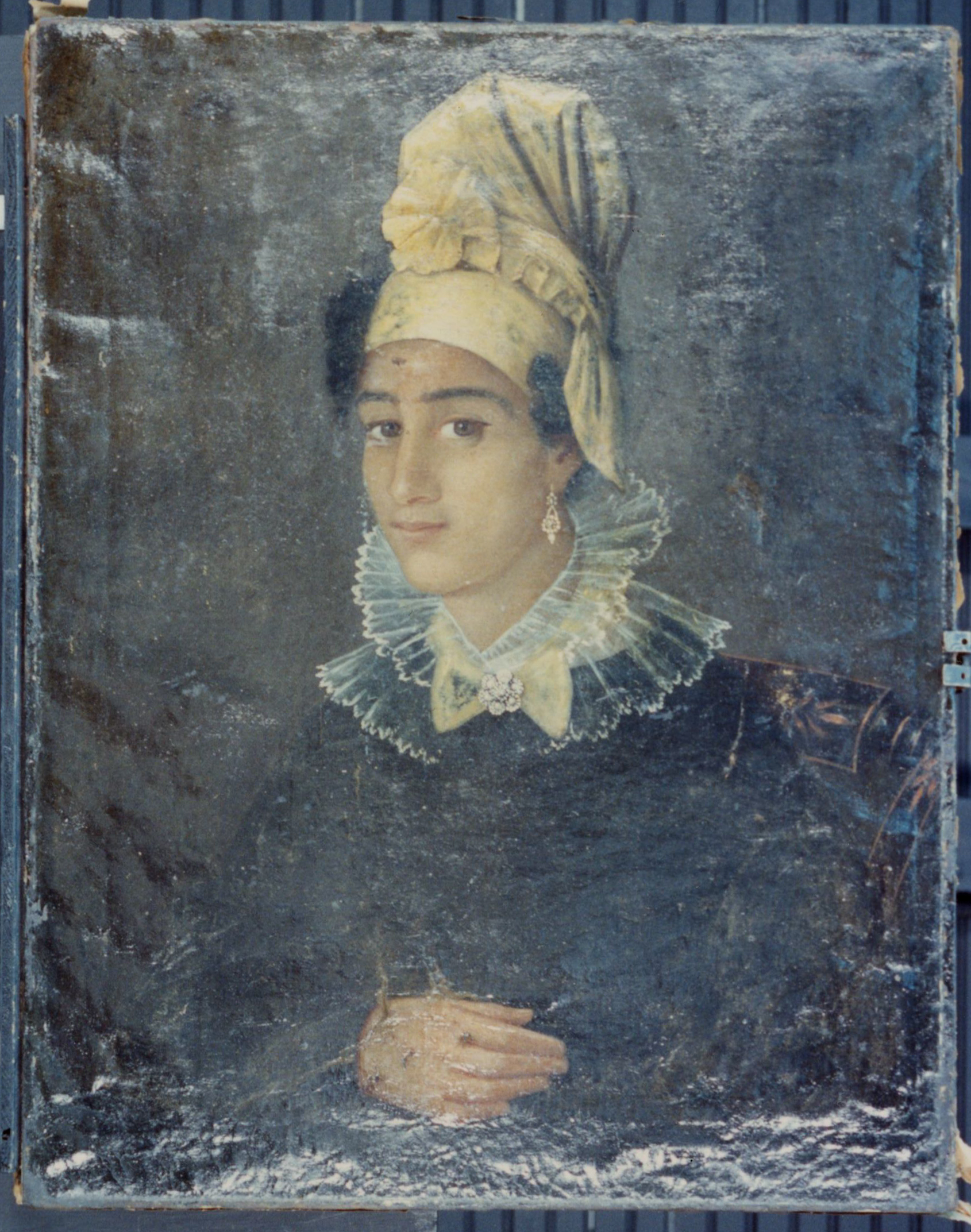 A portrait of a person wearing a ruffled collar and a tall, elaborate headpiece. The attire is historical, suggesting a style from the past centuries. The background is muted, emphasizing the subject’s calm expression and intricate clothing details.