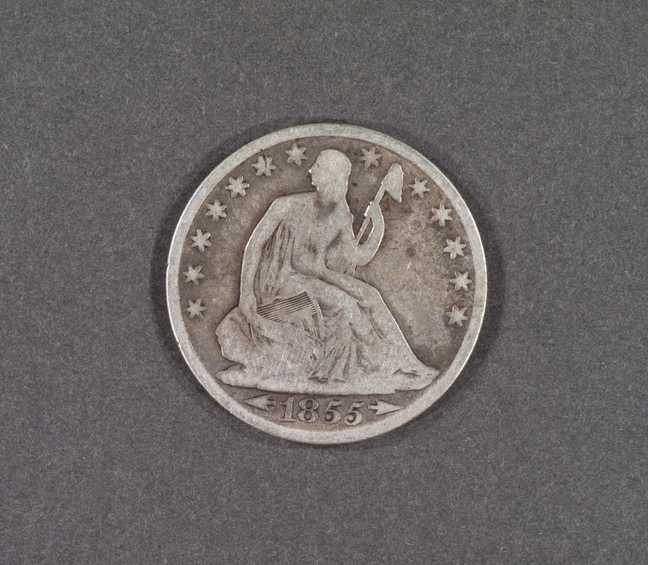 A vintage U.S. coin from 1855 featuring the Seated Liberty design. It shows a figure sitting and holding a staff, surrounded by stars on a grey background.