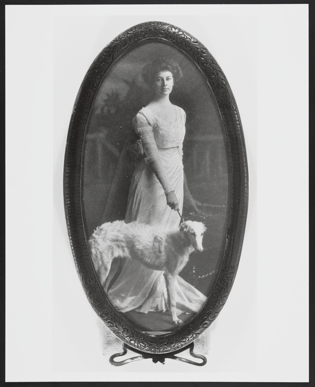 Black and white photo of Elizebeth Werlein posing with her Afgan hound.