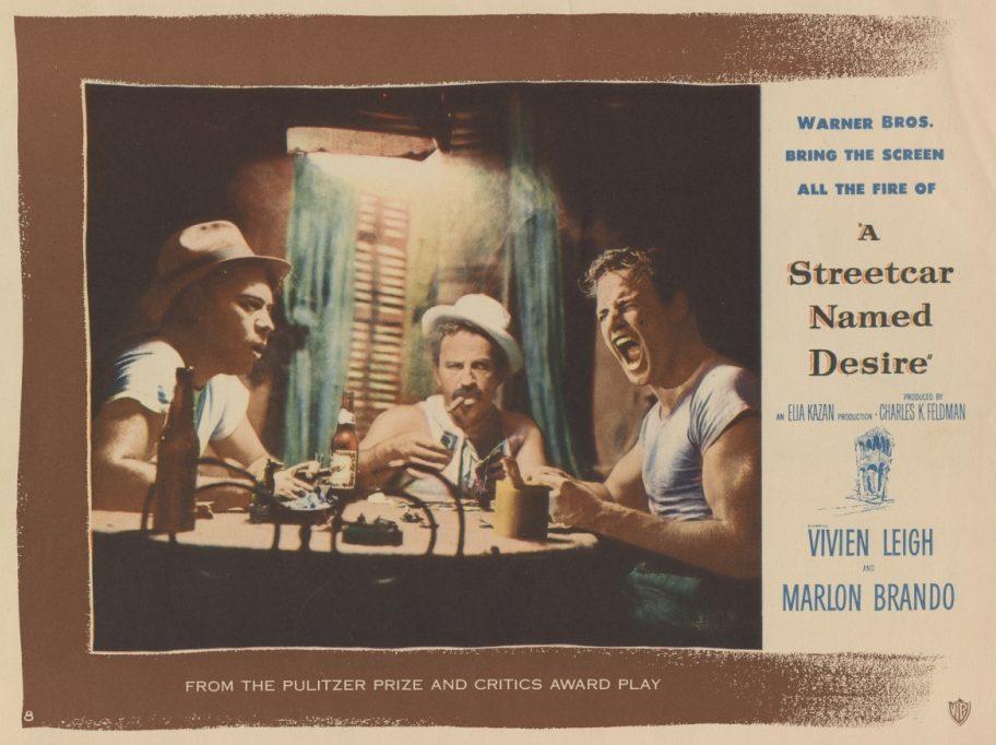 A vintage movie poster shows three men seated around a small table, engaged in an intense conversation. The poster is for A Streetcar Named Desire, featuring Vivien Leigh and Marlon Brando, with text highlighting its awards and production details.