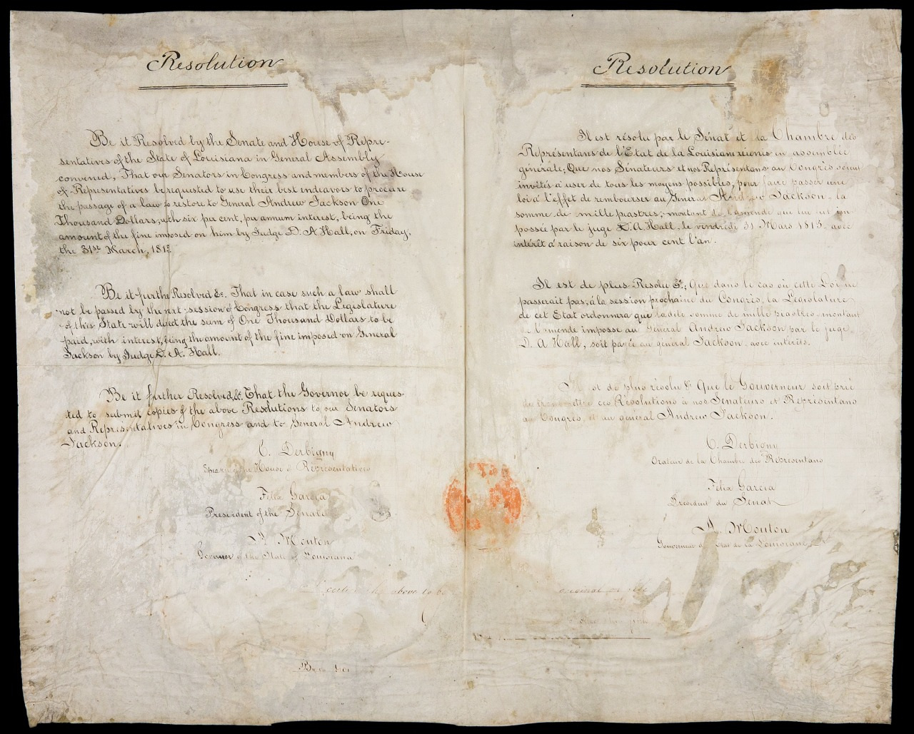 A historic document with handwritten text on aged, stained paper. It features the title Resolution and signatures at the bottom. The document is shown open, displaying two pages with visible creases and edges showing signs of wear.