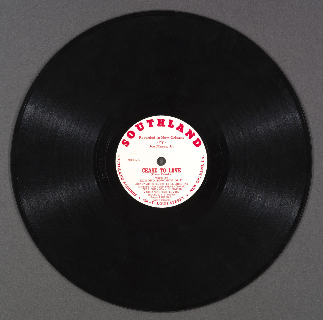 A black vinyl record with a white and red label in the center. The label reads Southland and includes the title Cease to Love performed by Edmond Souchon & His Milneburg Boys, Joe Mares, Jr. recorded in New Orleans.