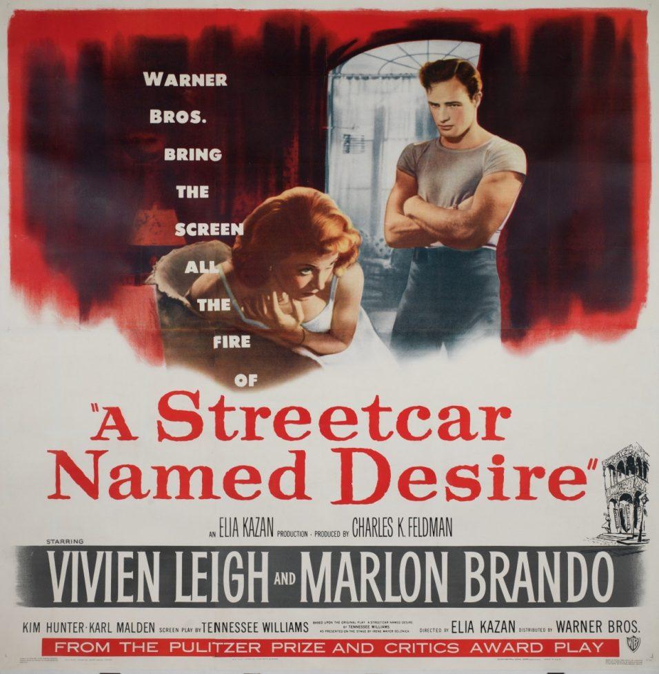 Poster for A Streetcar Named Desire, featuring a man in a white shirt standing with folded arms and a woman in a red dress leaning on her elbows. Bold text highlights the title and actors Vivien Leigh and Marlon Brando.