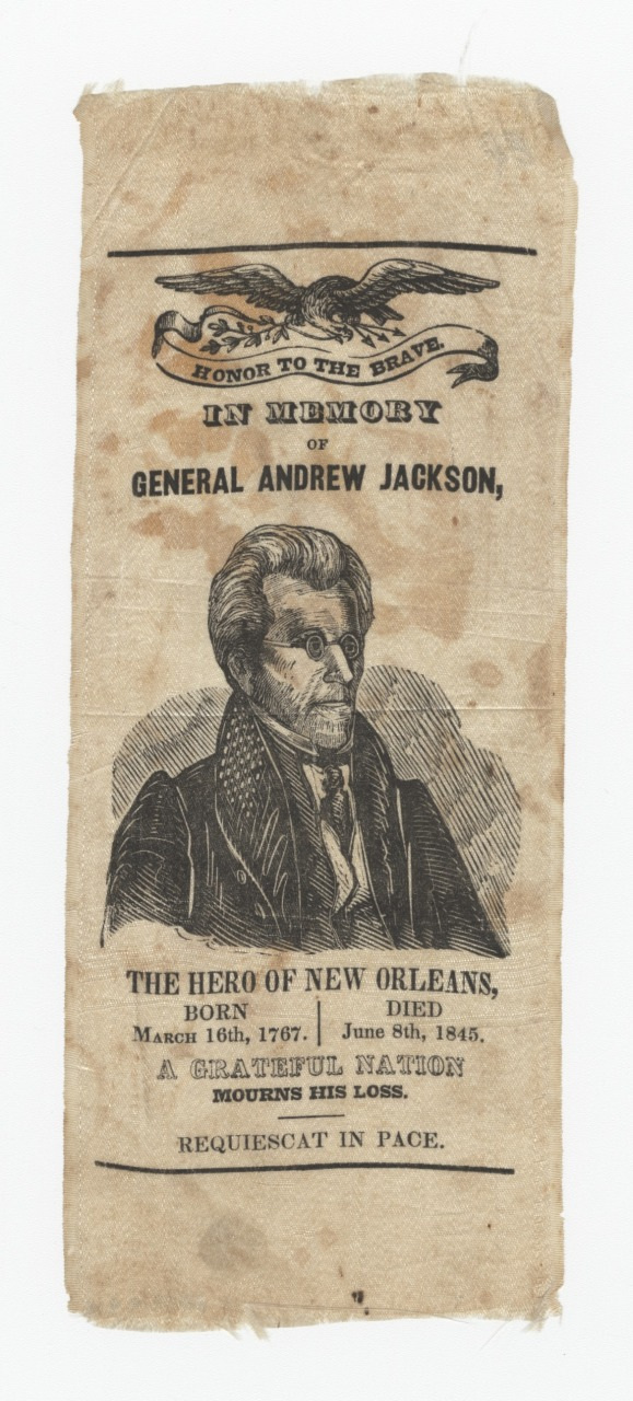 A vintage memorial ribbon featuring an illustration of General Andrew Jackson. Text includes Honor to the Brave, birth and death dates (March 15th, 1767 - June 8th, 1845), and references his role as The Hero of New Orleans.
