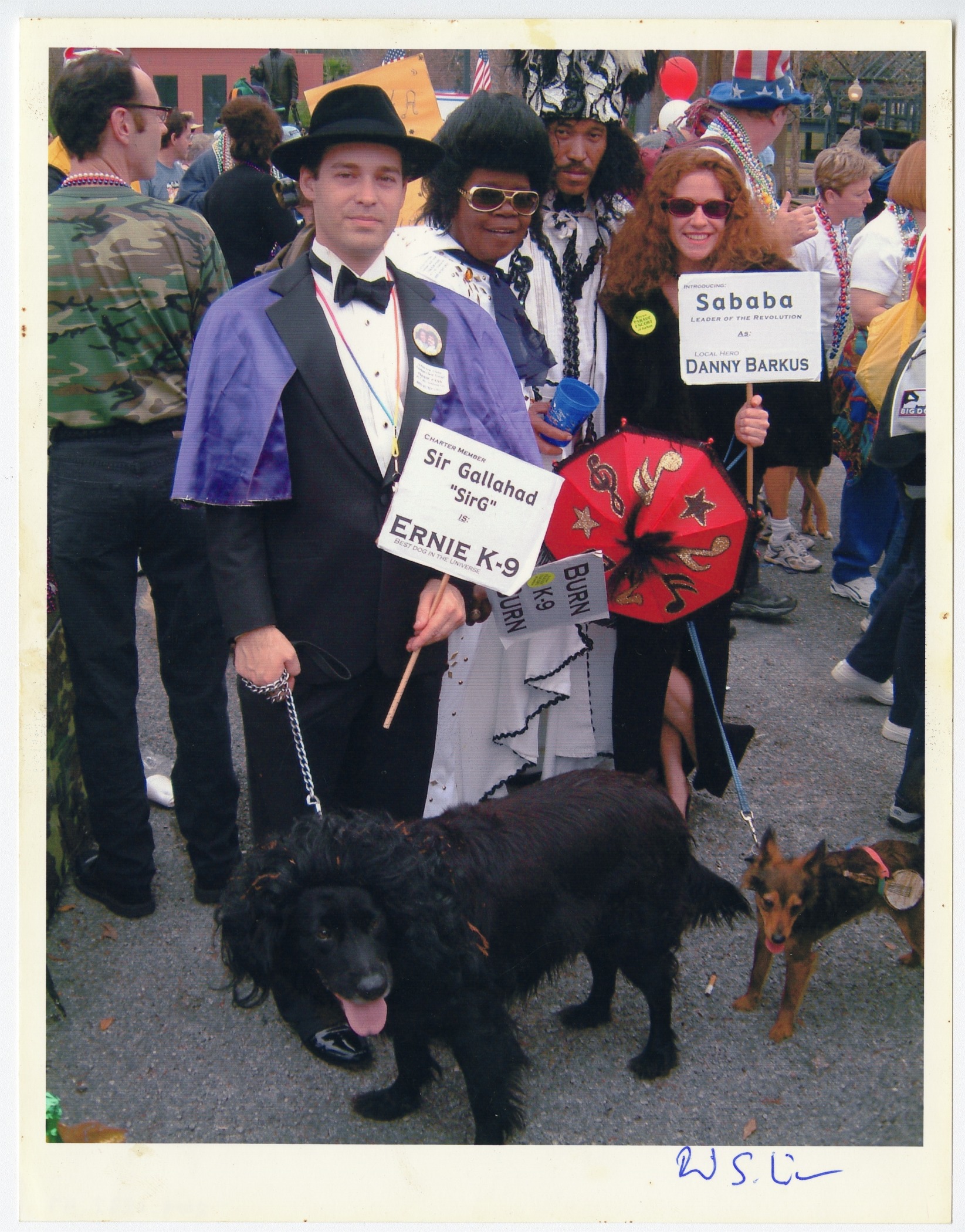 A photo of the annual Krewe of Barkus Mardi Gras parade, featuring dogs Ernie K-9, Danny Barkus, and their owners.