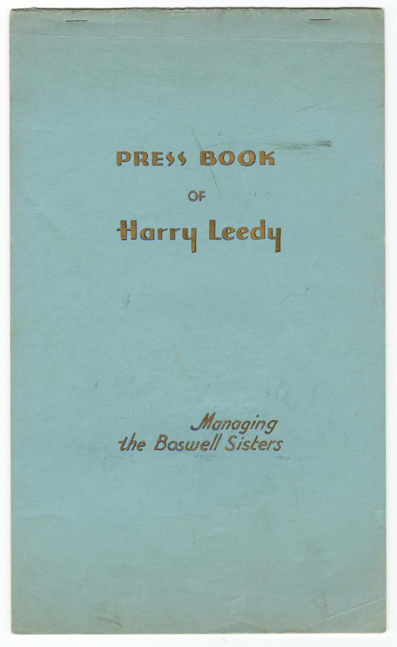 A blue cover titled Press Book of Harry Leedy in gold and brown letters. The subtitle reads Managing the Boswell Sisters. The cover is slightly worn with visible creases.