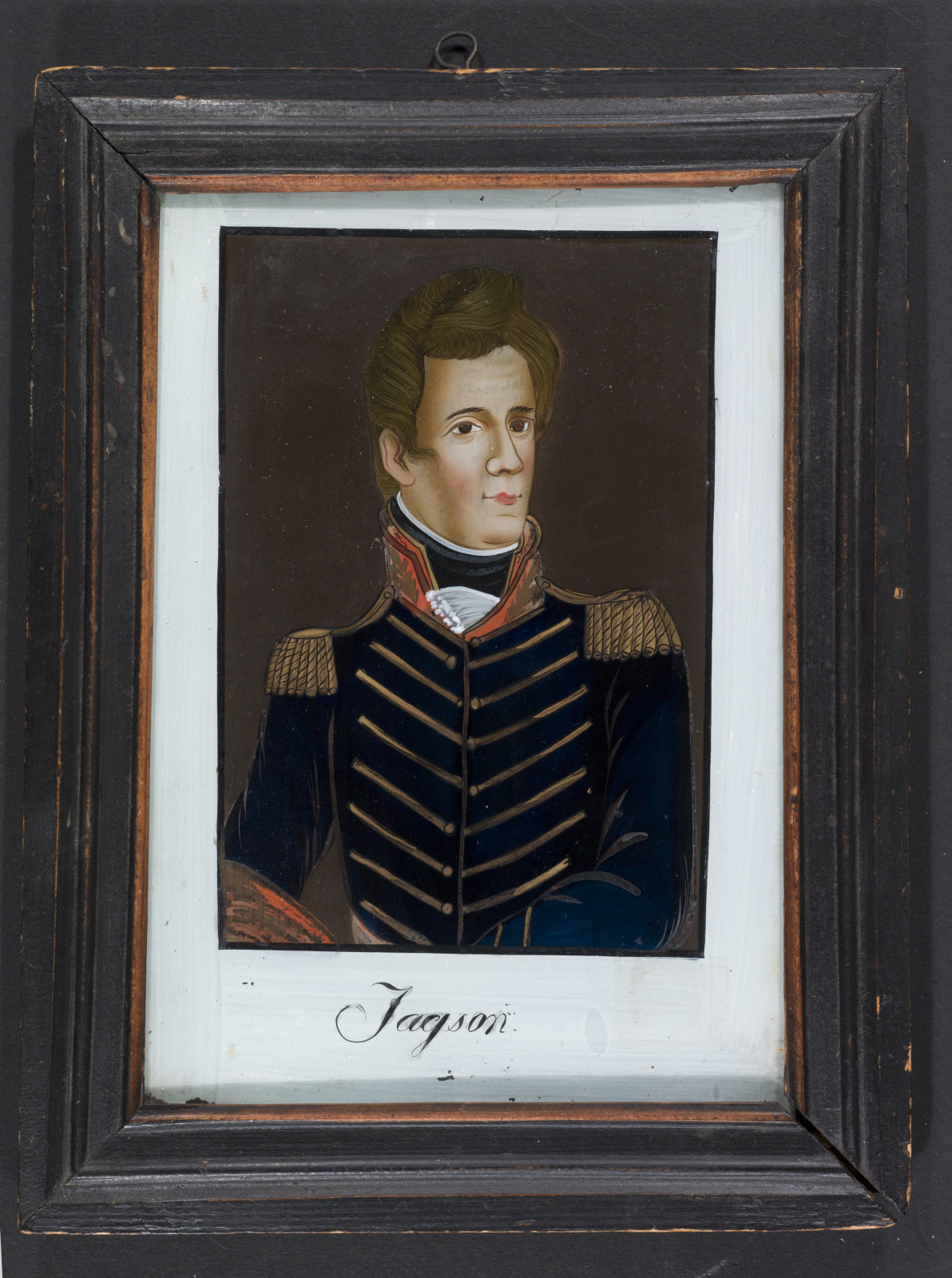 A framed portrait of a man in a military uniform with gold epaulets and intricate detailing. The name Jackson is written below the image.