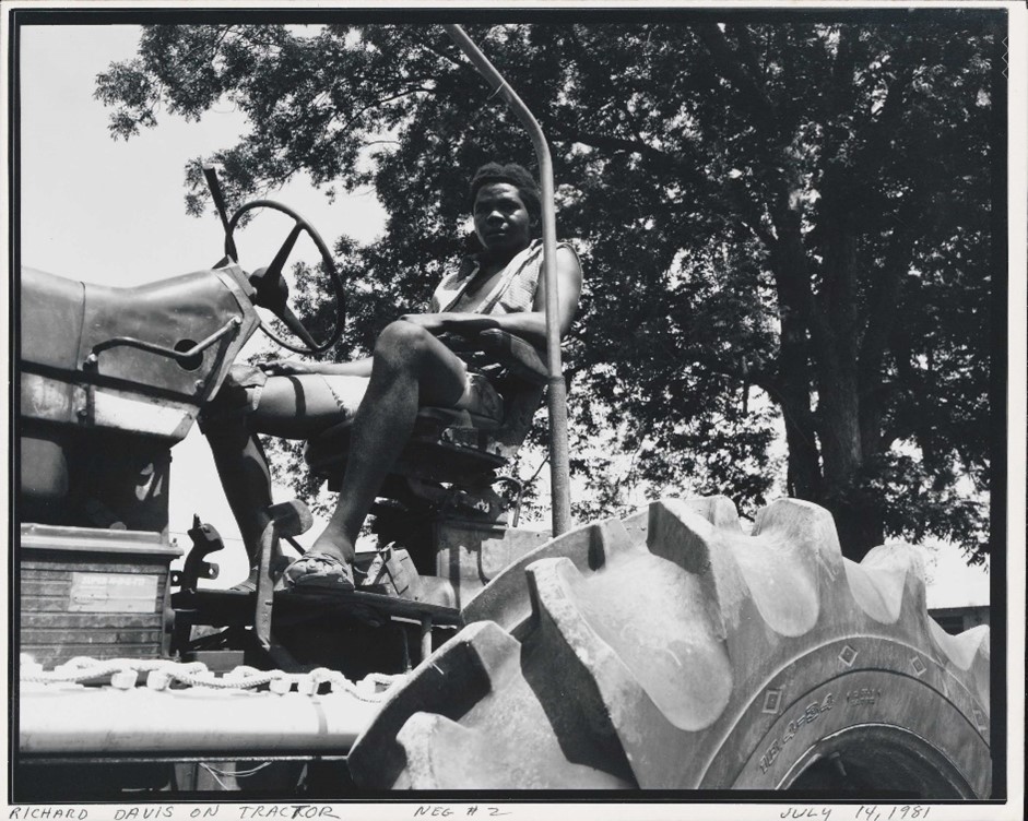 A black and white photo of Nottoway plantation worker Richard Davis on a tractor.