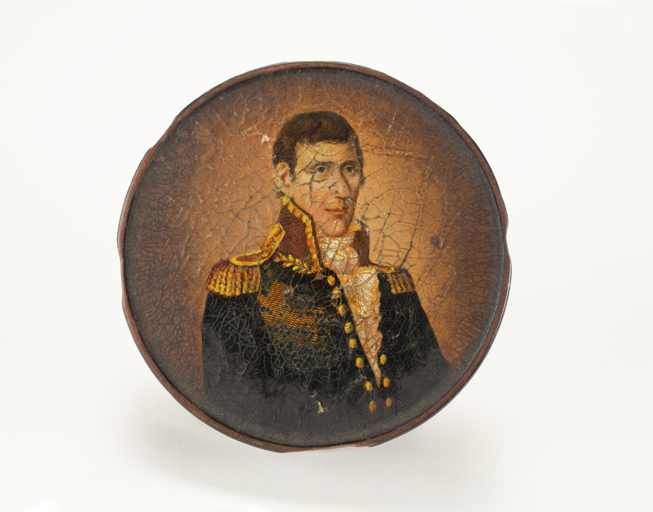 A circular, aged portrait depicts a man in a military uniform with gold epaulettes, set against a cracked, brownish background. The artwork shows signs of wear, suggesting historical significance.