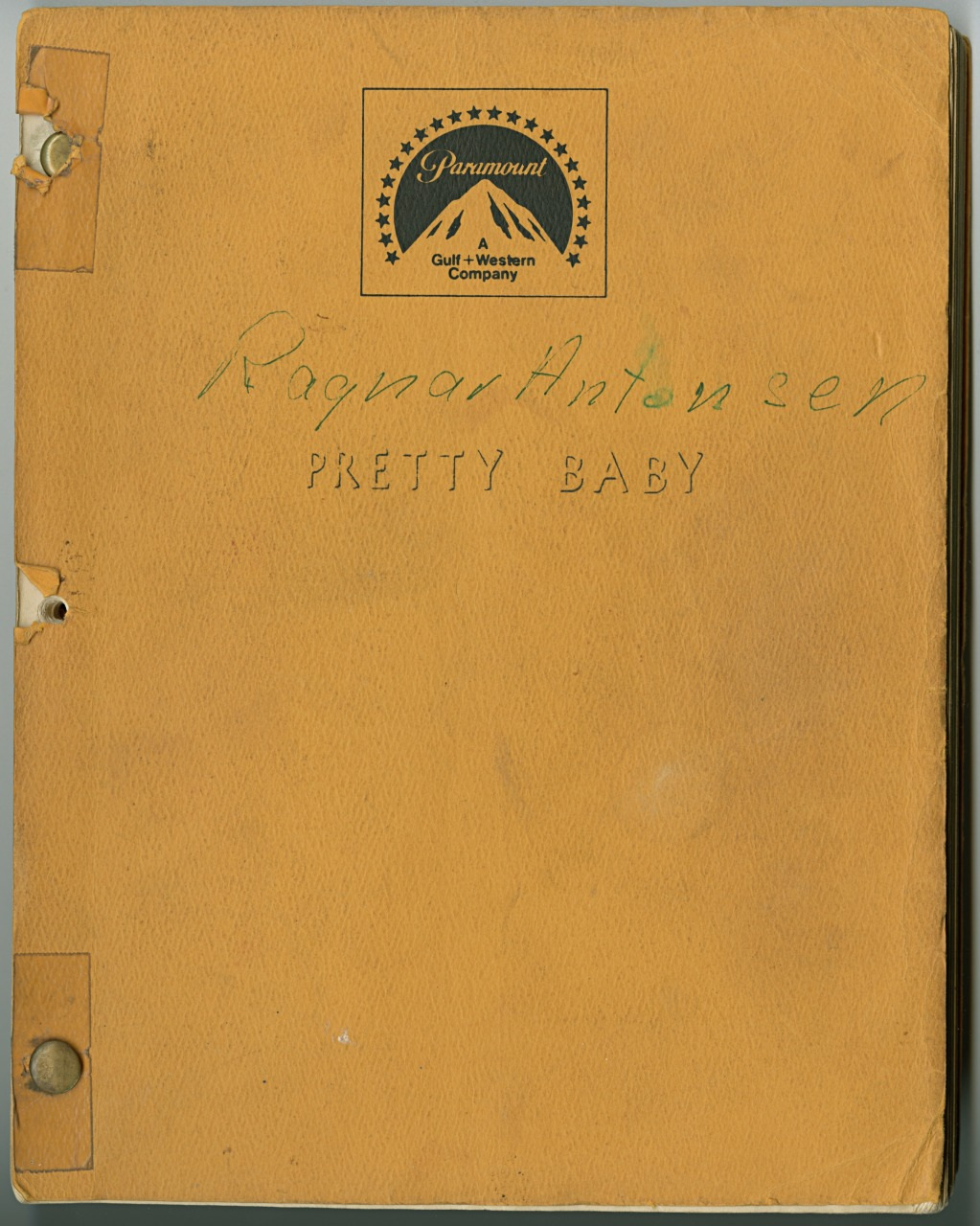 A worn, yellow script cover with Ragnar Antonsen and PRETTY BABY handwritten in green. The Paramount Gulf + Western Company logo is printed at the top. The cover shows holes for binding, indicating it was part of a larger document.