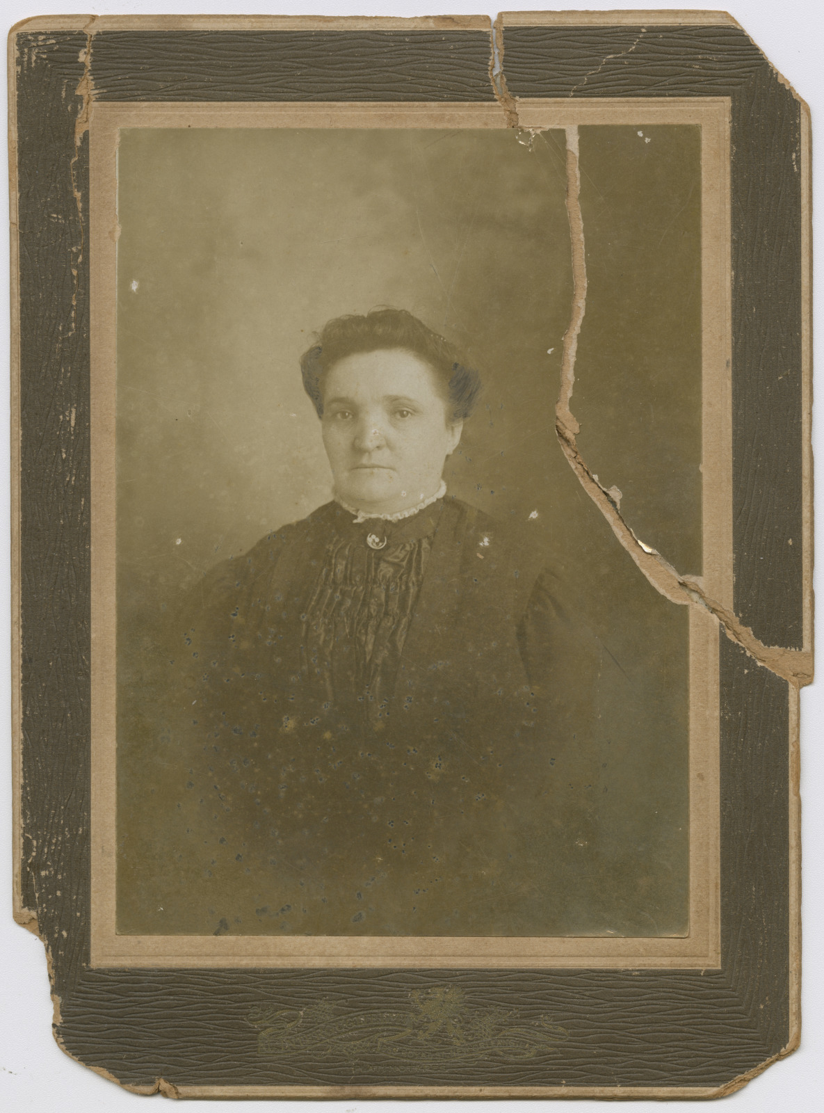 A sepia-toned and ripped portrait of Madame Begue.