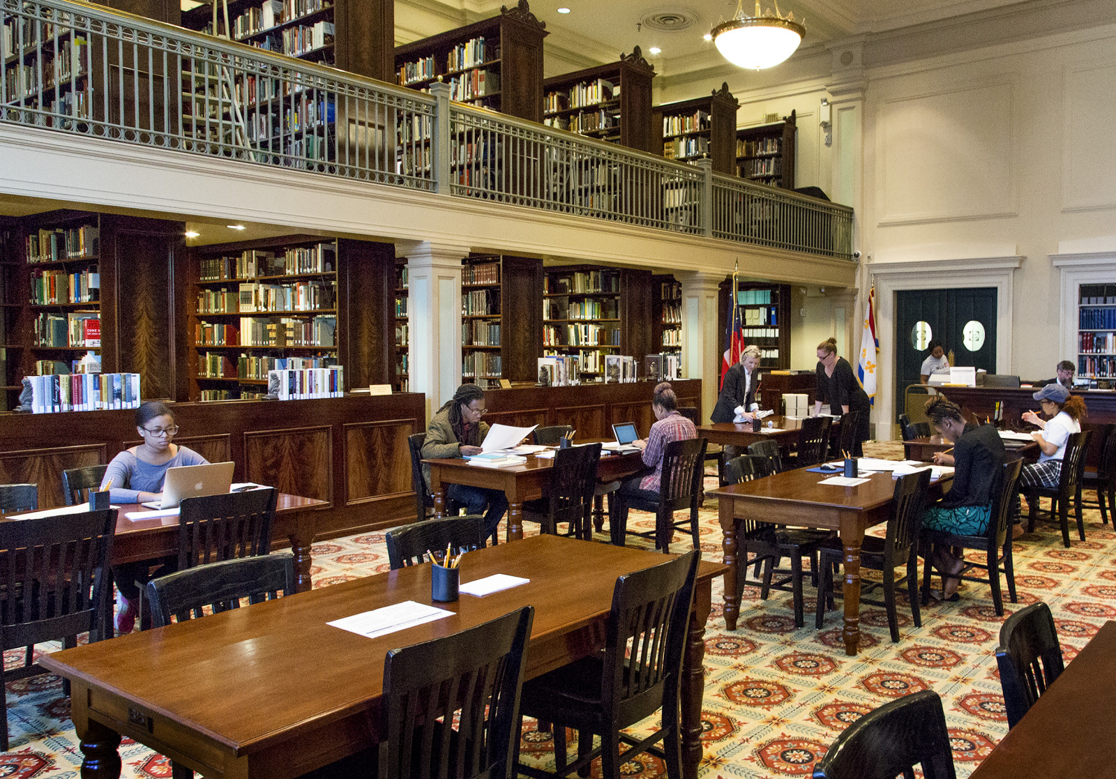 A group of students conduct research in the reading room of HNOC's Williams Research Center.