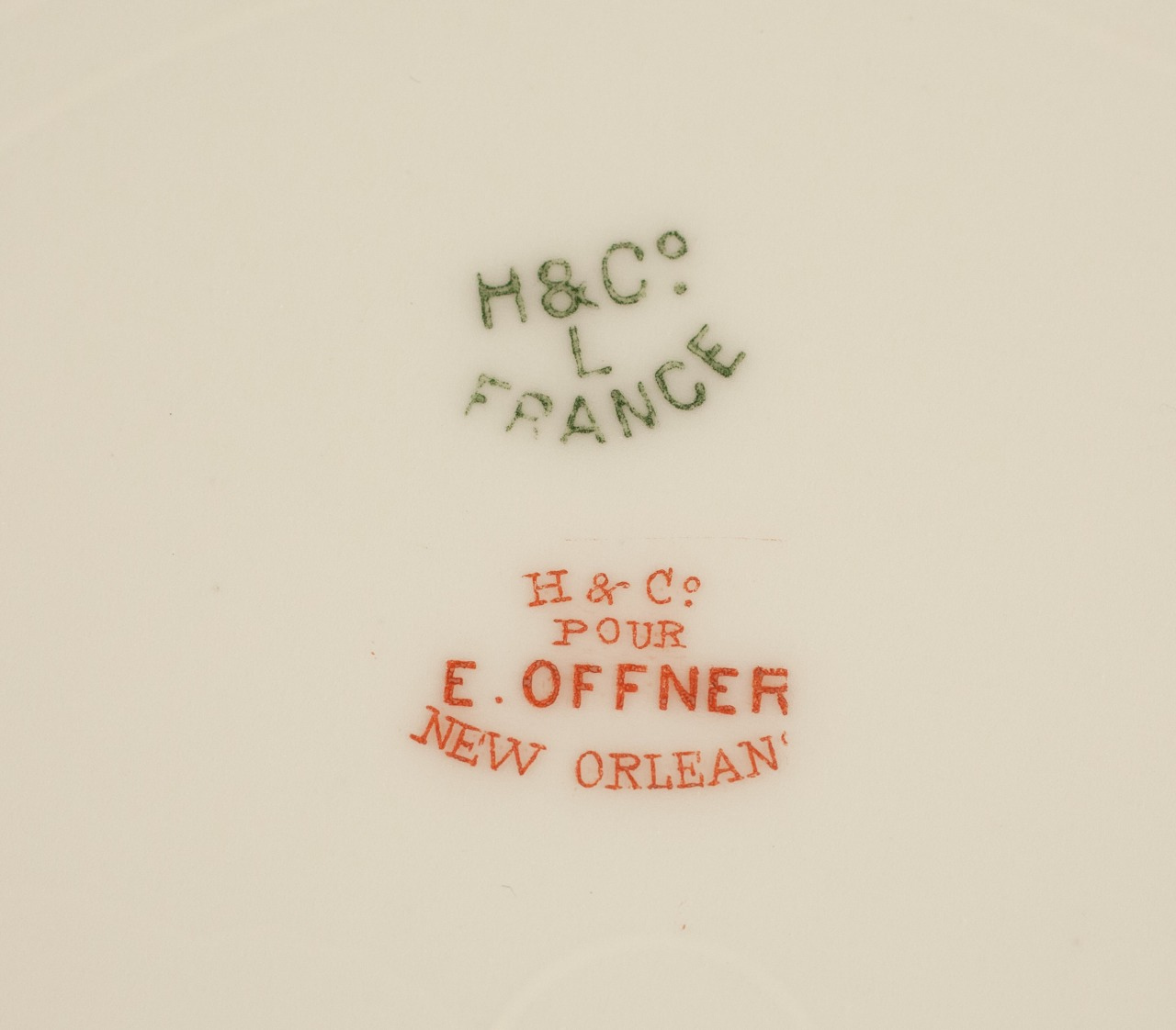 Close-up of porcelain markings. Green text reads H & Co. L FRANCE. Below, red text states H & Co. POUR E. OFFNER NEW ORLEANS.