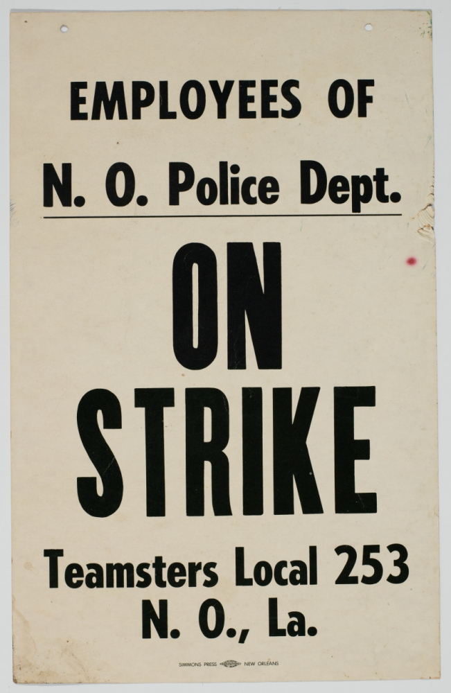 A vintage sign with bold black text on a white background reads, Employees of N.O. Police Dept. ON STRIKE Teamsters Local 253 N.O., La.