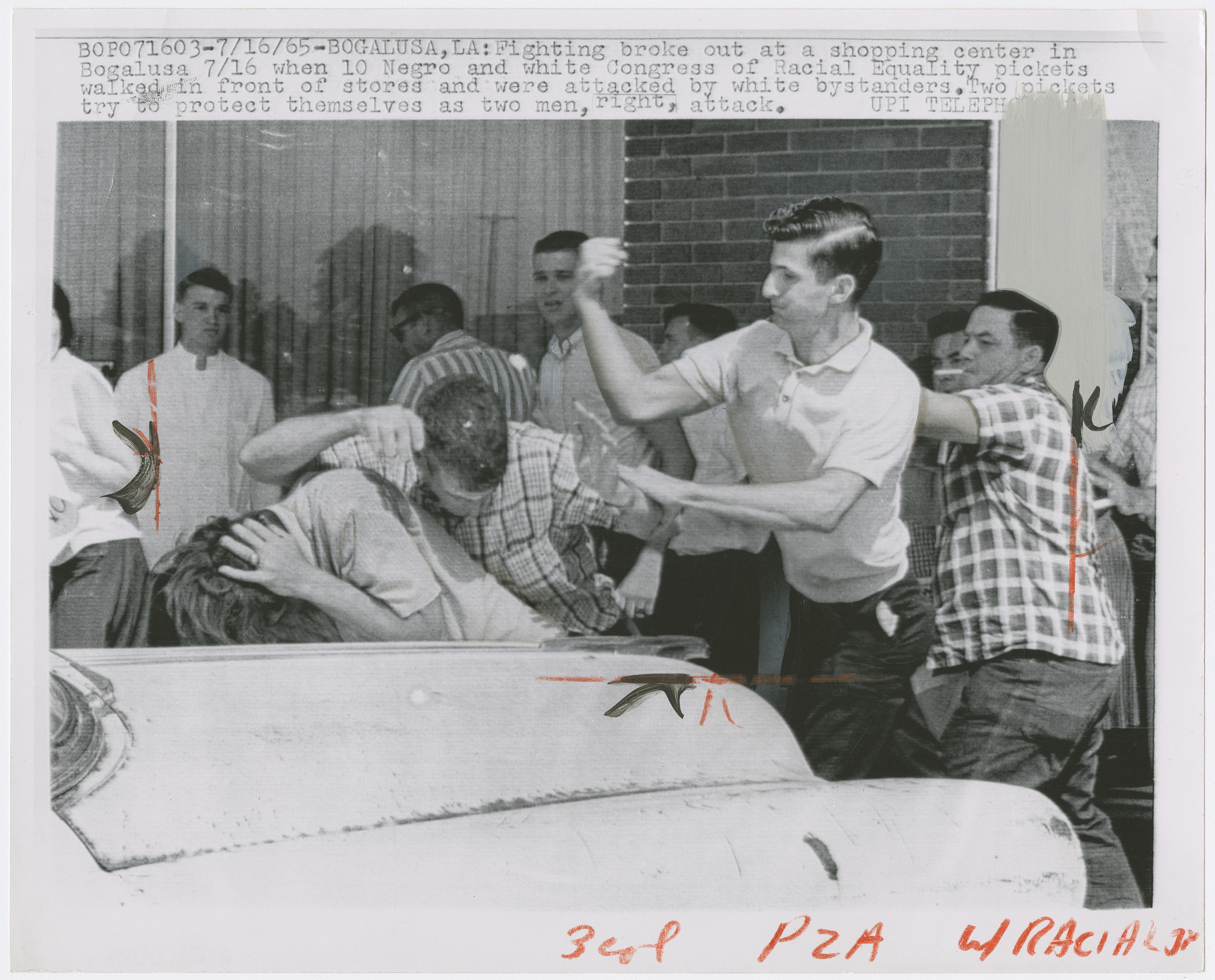 A black and white photograph shows a CORE activist being beaten by a white mob in Bogalusa, Louisiana, on July 17, 1965.