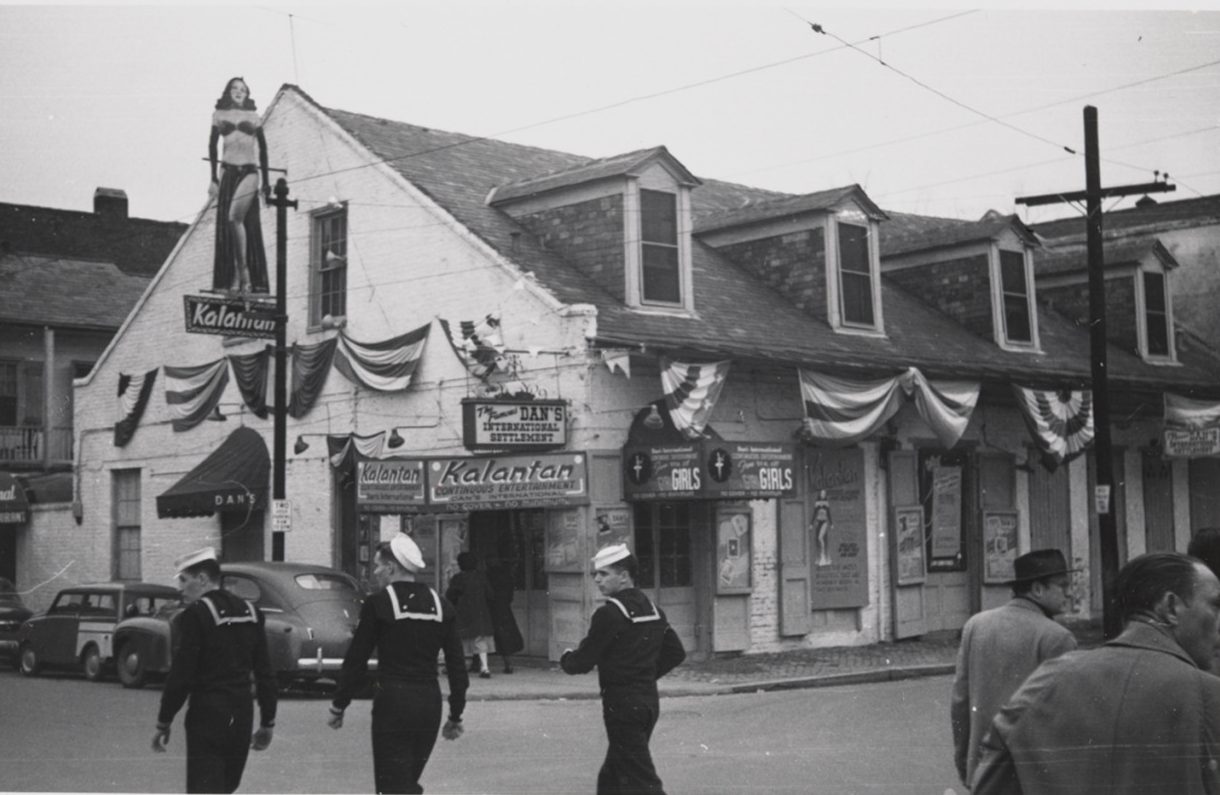 Three sailors cross Bourbon Street at Toulouse toward Dan’s International Settlement, 1952.