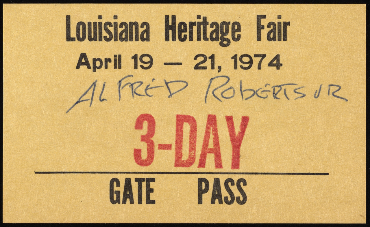 A vintage 3-day gate pass for the Louisiana Heritage Fair, dated April 19-21, 1974. The name Alfred Roberts Jr. is handwritten in blue ink on the pass.