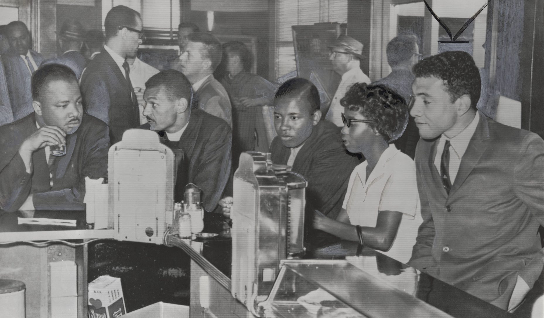 A black and white photo of Freedom Riders integrating a lunch counter in Montgomery, Alabama, on May 24, 1961.