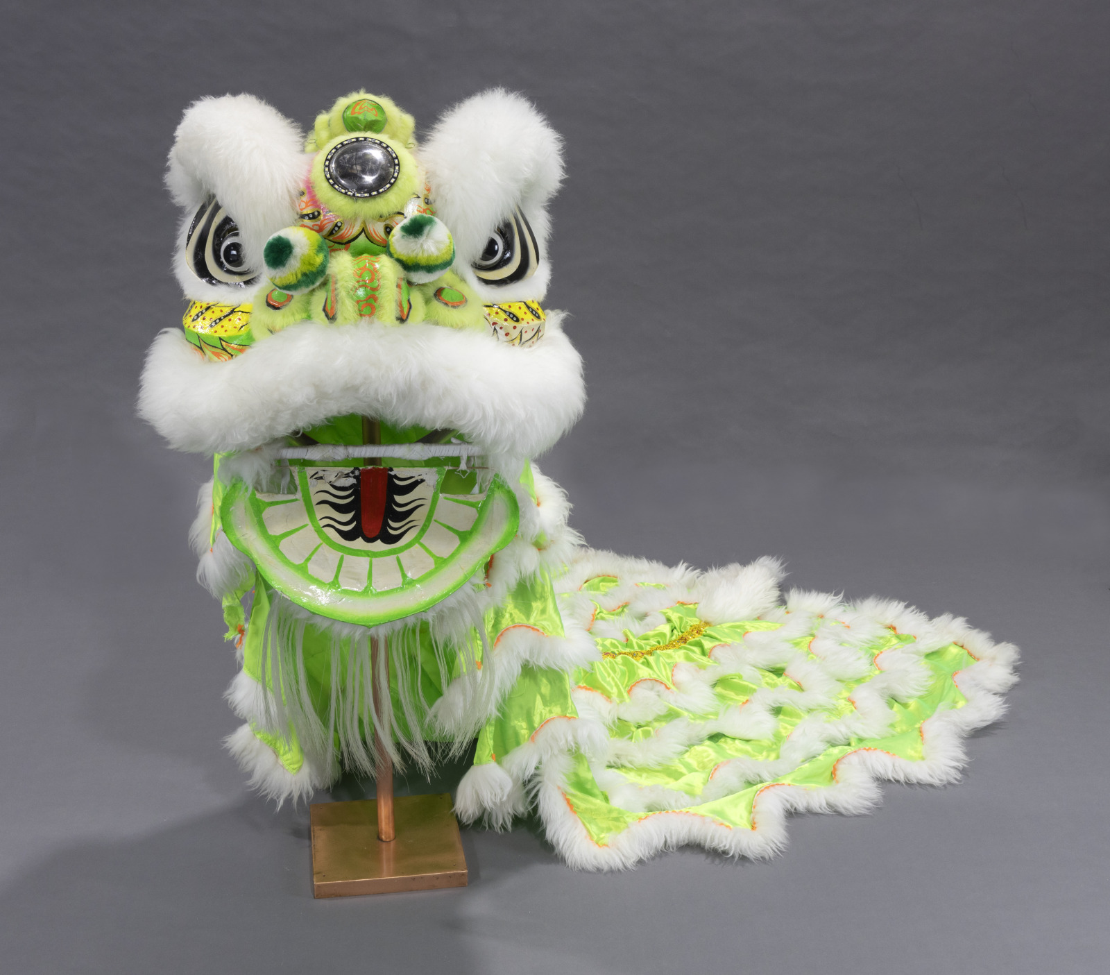 A traditional Vietnamese lion dance costume, adorned with lime green and faux fur decoration.