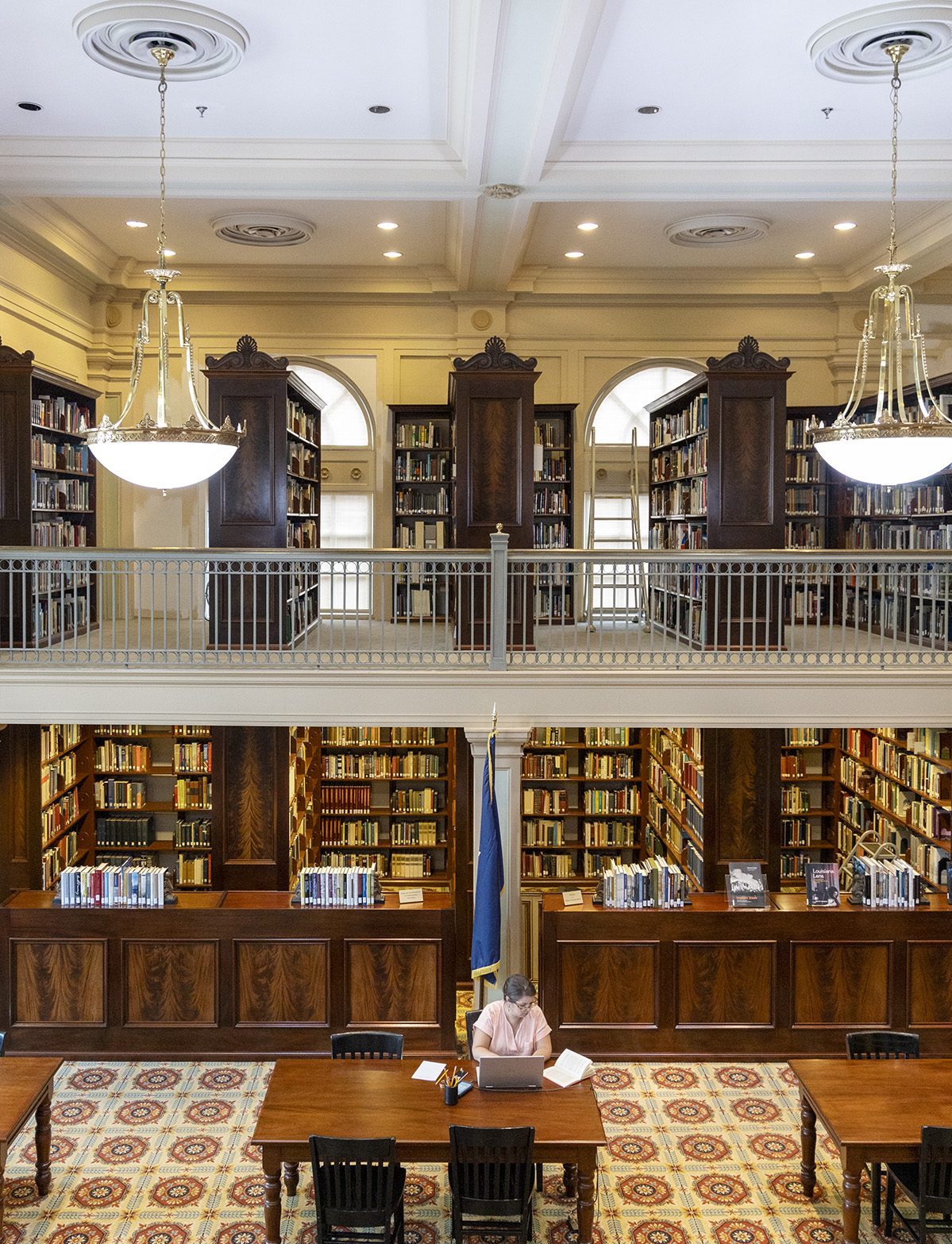 A visitor conducts research at a table in the Reading Room of HNOC's Williams Research Center.