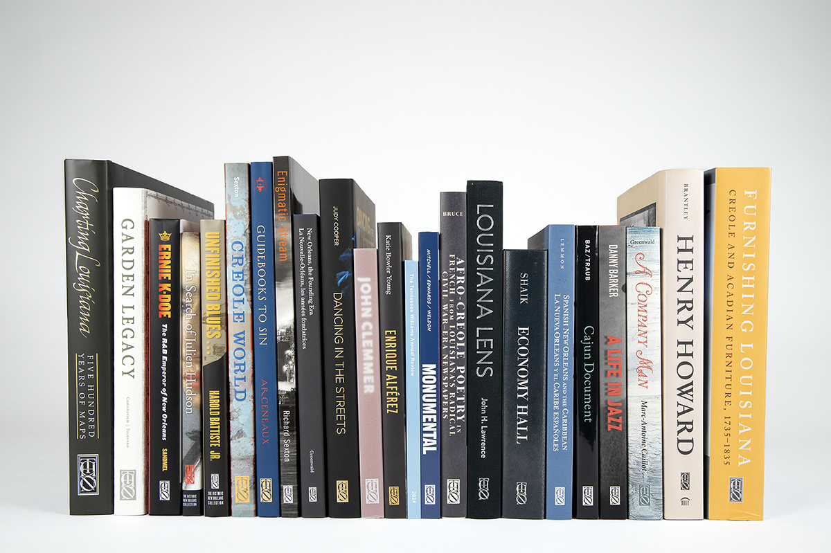 A row of diverse books with various titles and cover designs displayed upright against a plain white background.