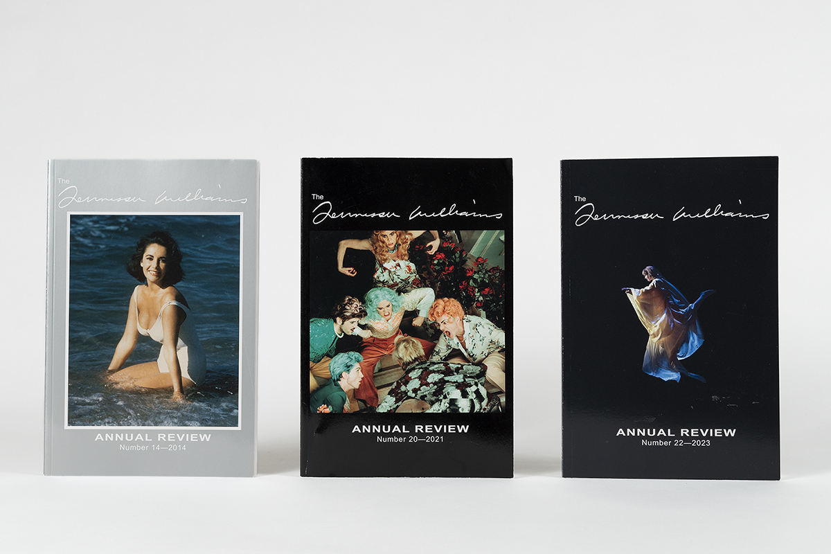 Three issues of an annual review are displayed vertically. The covers feature a woman in water, a theatrical scene, and a dancer with flowing fabric. Each cover has the title The Annual Review and publication years: 2014, 2021, and 2023.