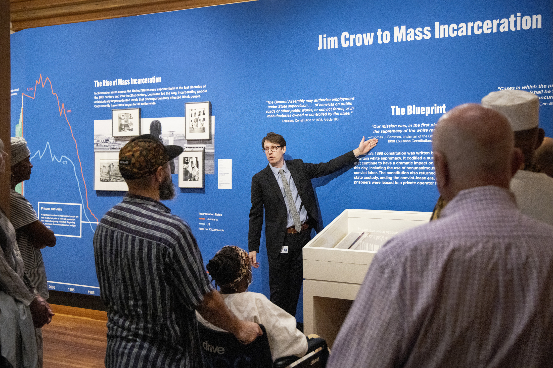 A tour guide gestures towards an exhibition display at HNOC.