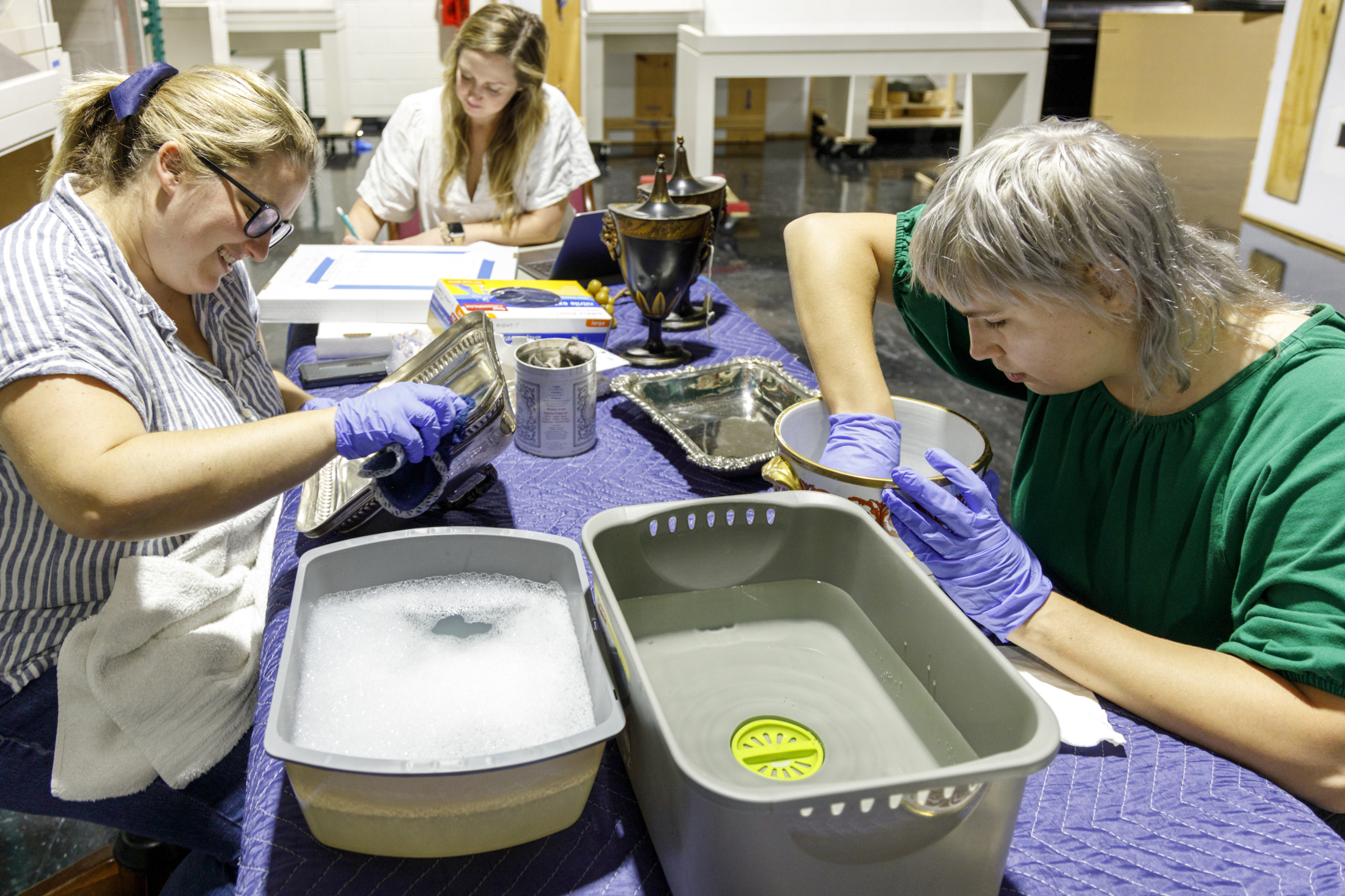 Lydia Blackmore and Kylie Hewitt clean items from the Williams Residence, currently closed as part of HNOC’s 533 Royal Street renovation.