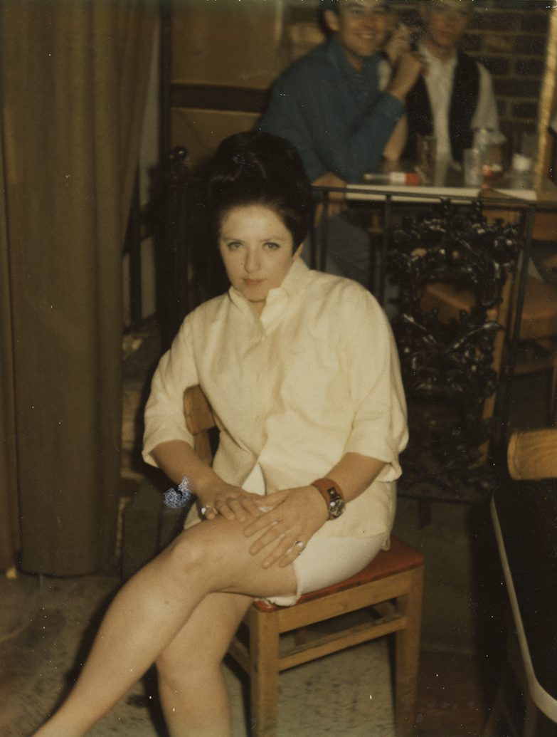 A vintage photo of lesbian activist Susan Dauzat sitting in a chair, taken in 1969.