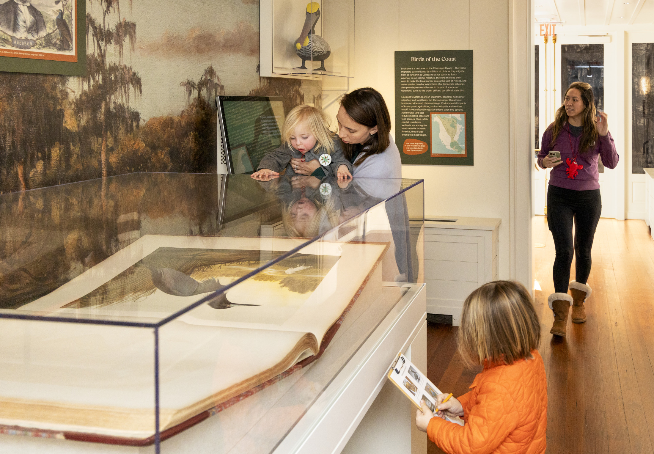 A group of children and their families participate in a program at HNOC.