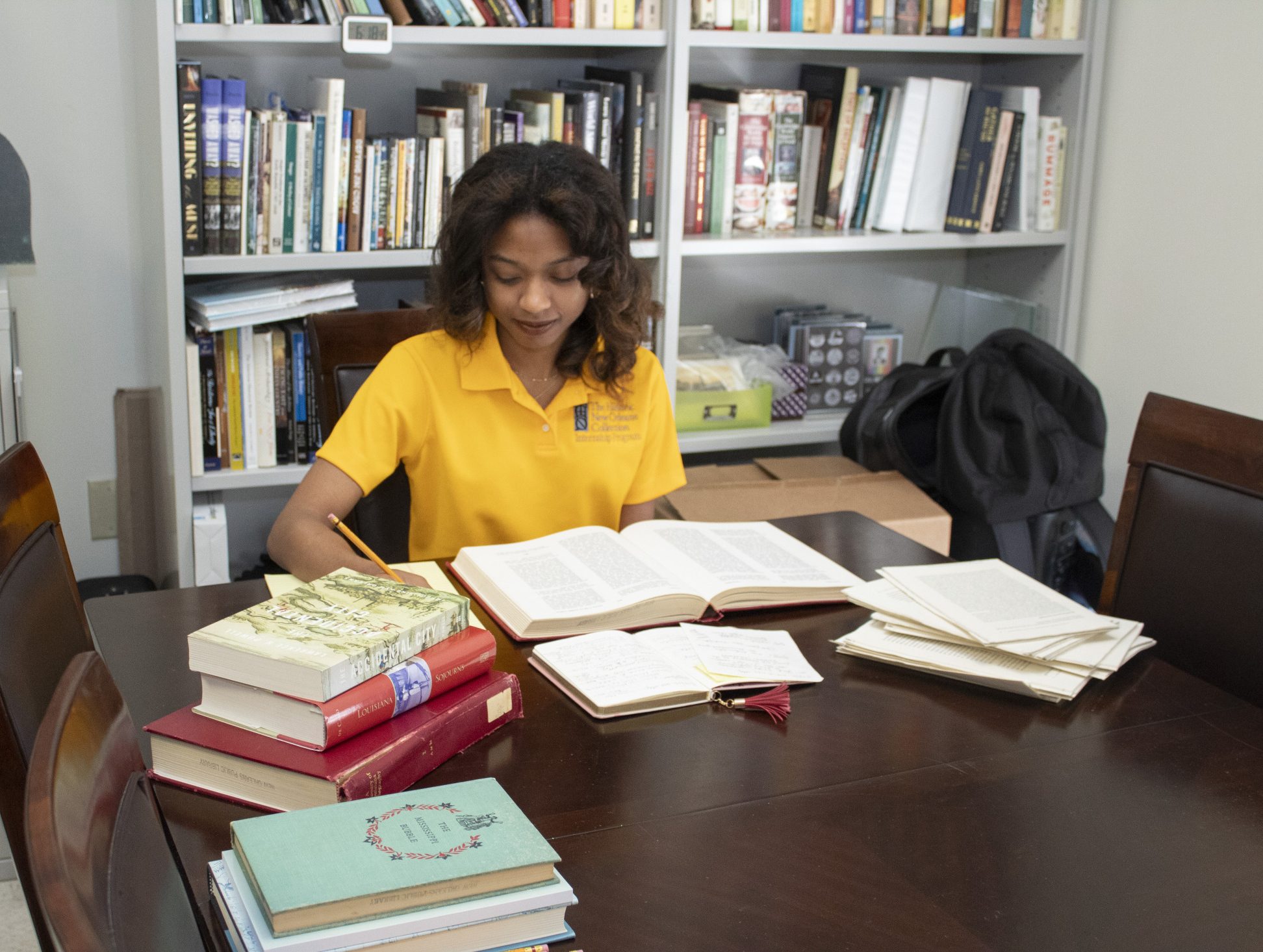 A Derven Scholar intern works at a desk at the Historic New Orleans Collection.