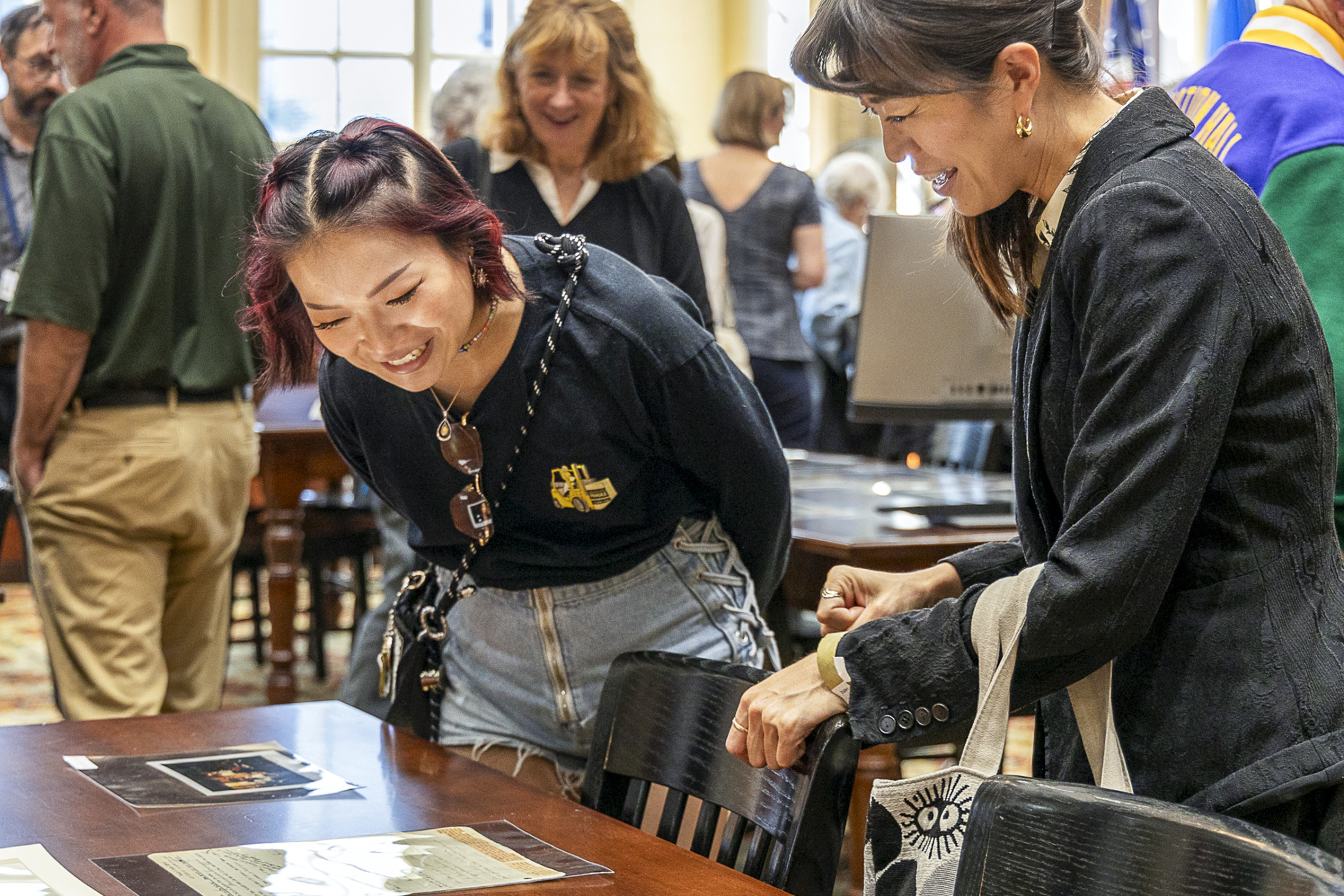 A group of people examine historical materials at HNOC's Williams Research Center.