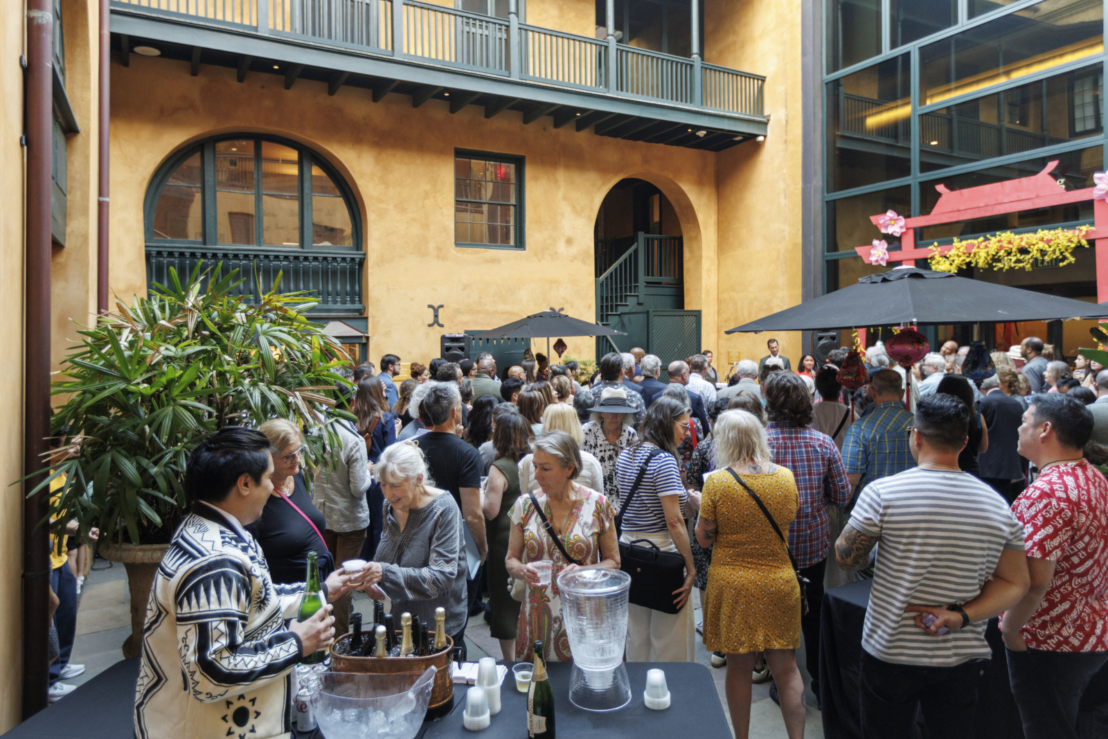 Audiences gather around a bar in HNOC's courtyard at 520 Royal Street.