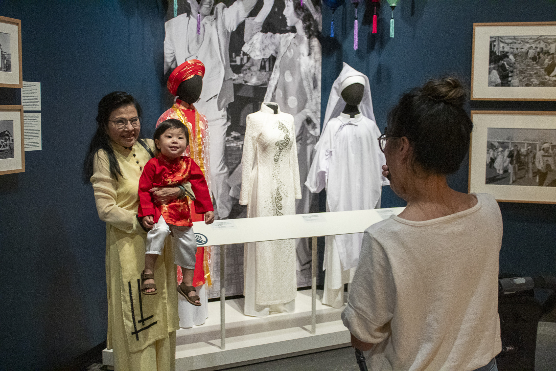 A group of museum visitors explore "Making It Home: From Vietnam to New Orleans".